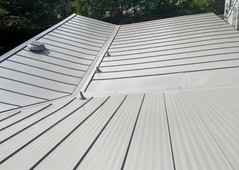 Solar attic fan installed on a metal roof for Roof Ventilation in Oak Park